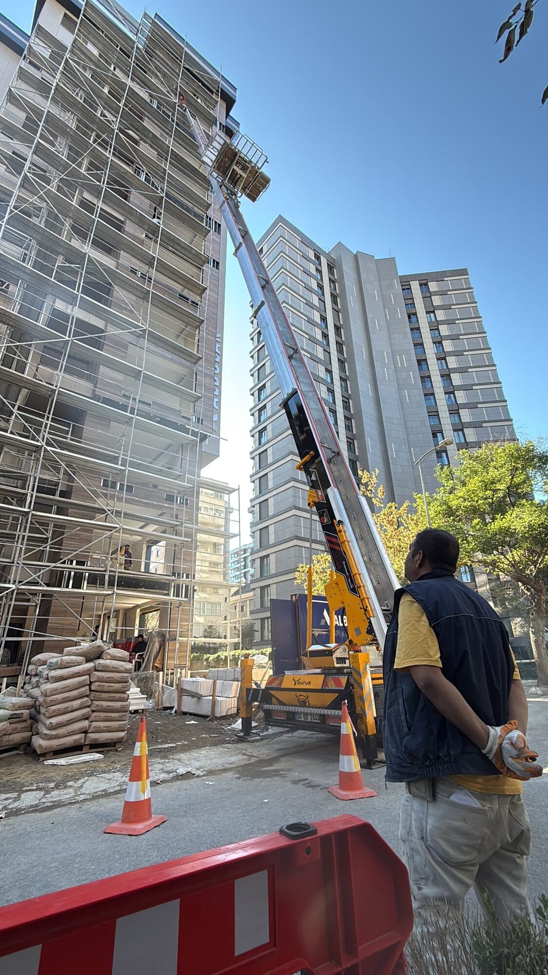 Uzman operatör gözetiminde yüksek binada asansörlü taşıma operasyonu