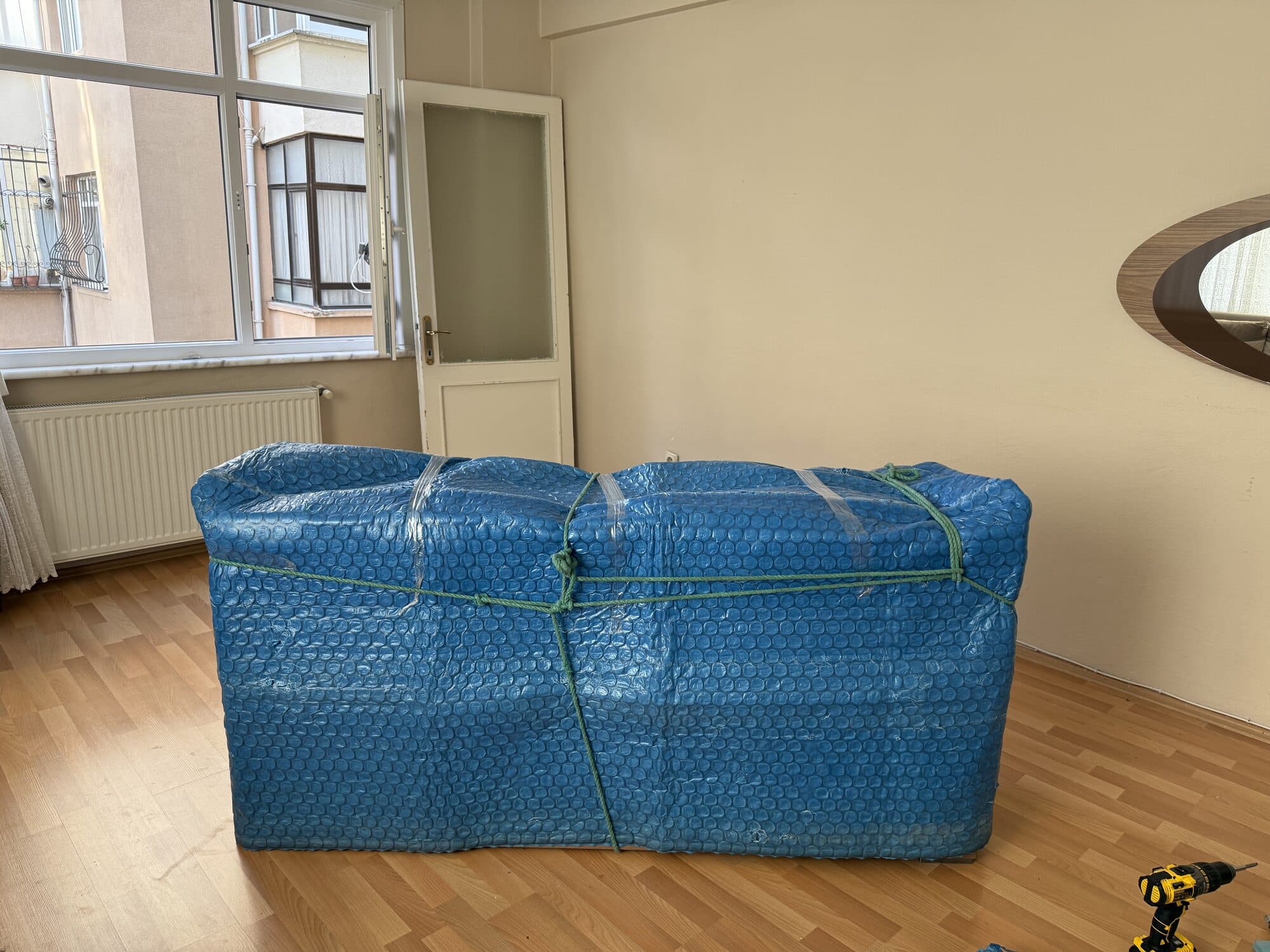Balonlu naylonla paketlenmiş koltuk — hasarsız evden eve taşıma hazırlığı