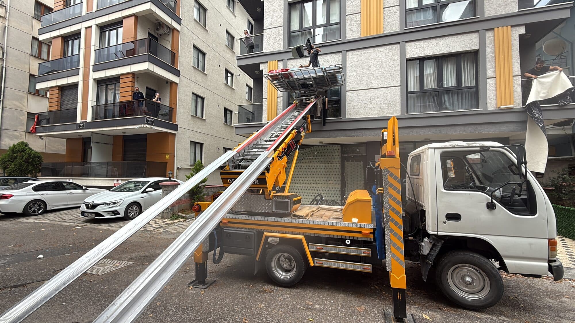 Dış cephe eşya asansörü ile apartmandan eşya taşıyan asansörlü nakliyat aracı